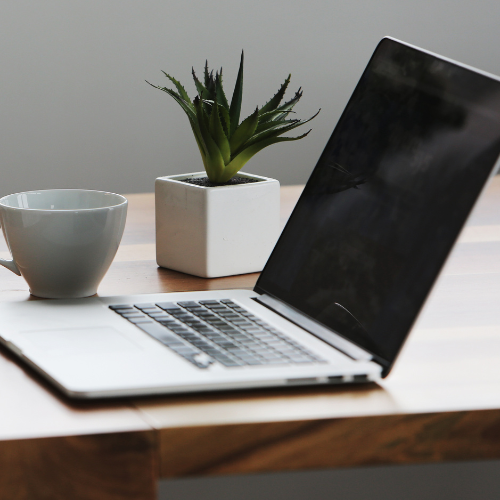 A laptop of a desk.