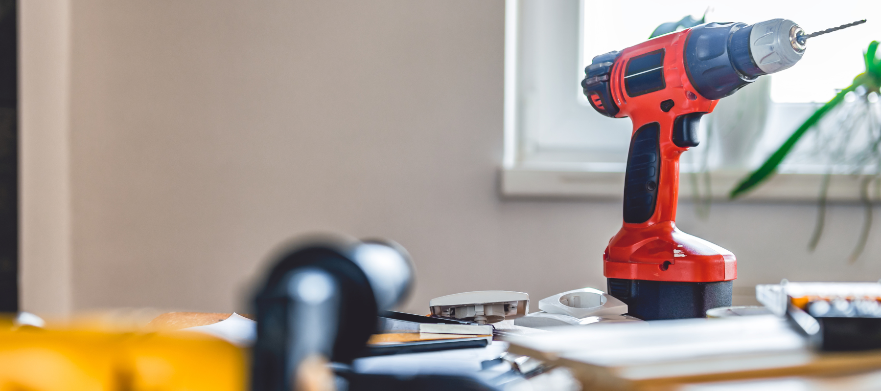 Power drill and supplies spread across a counter.